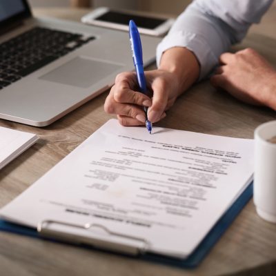 Close up of unrecognizable businesswoman signing a contract in the office.